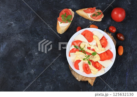 Caprese Bruschetta toast with mozzarella cheese, cherry tomatoes and fresh garden Basil.Traditional Italian food, healthy natural Breakfast, cholesterol-free and GMO-free, space for text, selective 125632130