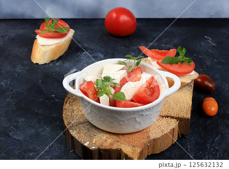 Caprese Bruschetta toast with mozzarella cheese, cherry tomatoes and fresh garden Basil.Traditional Italian food, healthy natural Breakfast, cholesterol-free and GMO-free, space for text, selective 125632132