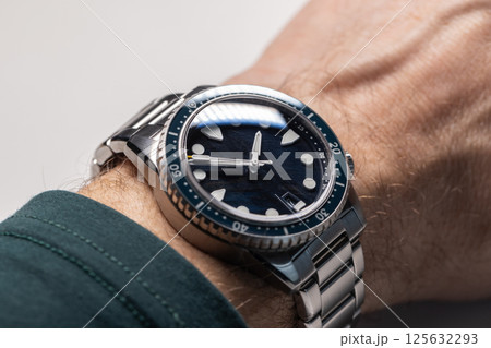 A detailed close-up of a modern wristwatch with a stainless steel strap A detailed close-up of a modern wristwatch with a stainless steel strap 125632293