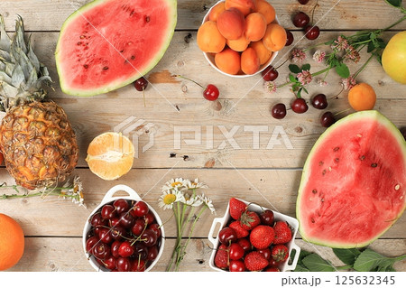 Summer berries and fruits on wooden background, harvesting in the village, healthy natural food concept, breakfast with ingredients, top view, shop advertisement, business card for cafe, selective 125632345