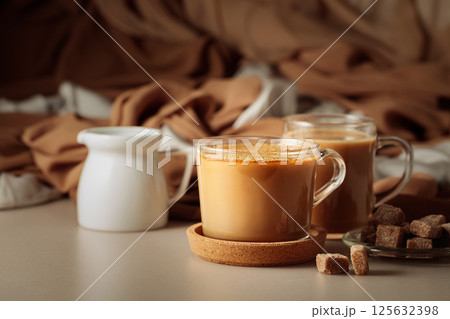 Latte with brown sugar on a beige background. 125632398