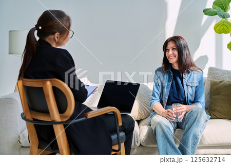 Positive woman at therapy session in psychologist therapist office 125632714