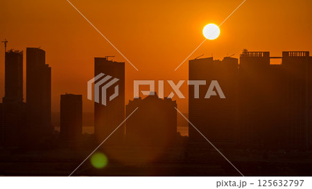 Buildings on Al Reem island in Abu Dhabi at sunset timelapse from above. 125632797