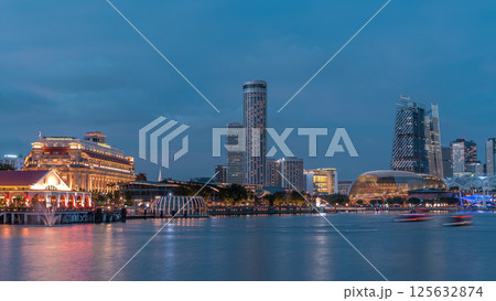 City skyline with skyscrapers and Esplanade Theatres on the Bay in Singapore at dusk, with beautiful reflection in water day to night timelapse City skyline with skyscrapers and Esplanade Theatres on the Bay in Singapore at dusk, with beautiful reflection in water day to night timelapse 125632874