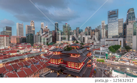 The Buddha Tooth Relic Temple comes alive at night in Singapore Chinatown day to night timelapse, with the city skyline in the background. The Buddha Tooth Relic Temple comes alive at night in Singapore Chinatown day to night timelapse, with the city skyline in the background. 125632917