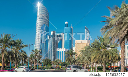 Corniche boulevard beach park along the coastline in Abu Dhabi timelapse with skyscrapers on background. Corniche boulevard beach park along the coastline in Abu Dhabi timelapse with skyscrapers on background. 125632937