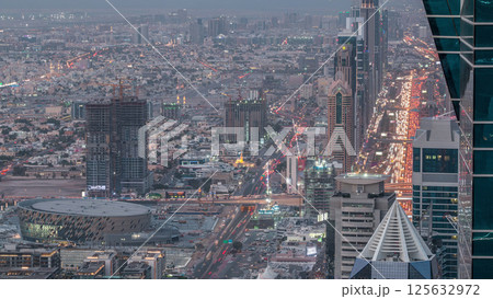 Skyscrapers on Sheikh Zayed Road and DIFC aerial day to night timelapse in Dubai, UAE. Skyscrapers on Sheikh Zayed Road and DIFC aerial day to night timelapse in Dubai, UAE. 125632972