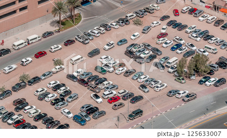 Aerial view full cars at large outdoor parking lots timelapse in Dubai, UAE. Aerial view full cars at large outdoor parking lots timelapse in Dubai, UAE. 125633007