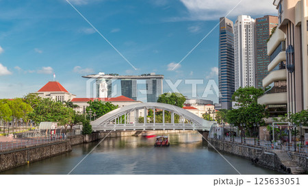 Skyline of Singapore financial district behind Elgin Bridge and the Singapore River timelapse hyperlapse 125633051