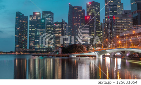 Esplanade bridge and downtown core skyscrapers in the background Singapore night to day timelapse 125633054
