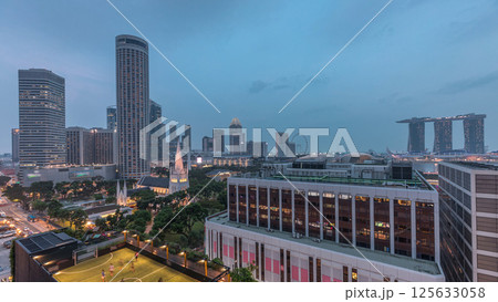Singapore skyline with St. Andrew's Cathedral aerial day to night timelapse. Singapore skyline with St. Andrew's Cathedral aerial day to night timelapse. 125633058