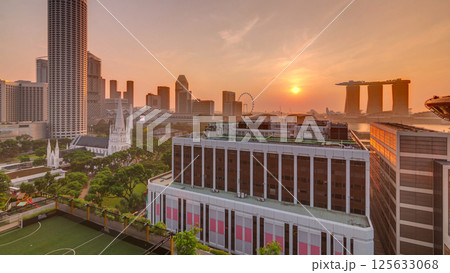 Sunrise over Singapore skyline with St. Andrew's Cathedral aerial night timelapse. Sunrise over Singapore skyline with St. Andrew's Cathedral aerial night timelapse. 125633068