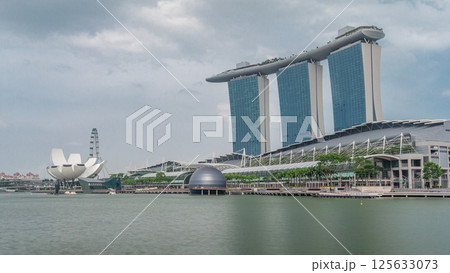 Fifty-five storeys high Marina Bay Sands Hotel dominates the skyline at Marina Bay in Singapore timelapse hyperlapse. 125633073
