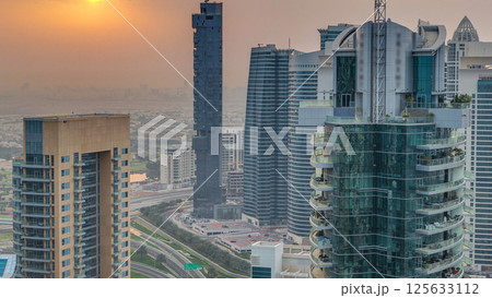 Aerial top view of sunrise in Dubai Marina timelapse. Modern towers and traffic on the road Aerial top view of sunrise in Dubai Marina timelapse. Modern towers and traffic on the road 125633112