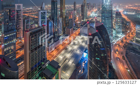 Skyline of the buildings of Sheikh Zayed Road and DIFC aerial day to night timelapse in Dubai, UAE. Skyline of the buildings of Sheikh Zayed Road and DIFC aerial day to night timelapse in Dubai, UAE. 125633127
