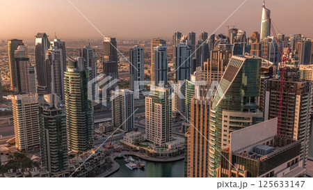 Dubai Marina skyscrapers and jumeirah lake towers sunrise view from the top aerial timelapse in the United Arab Emirates. 125633147