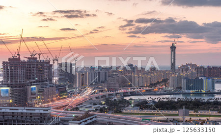 Palm Jumeirah Highway bridge aerial day to night timelapse. Dubai, United Arab Emirates Palm Jumeirah Highway bridge aerial day to night timelapse. Dubai, United Arab Emirates 125633150