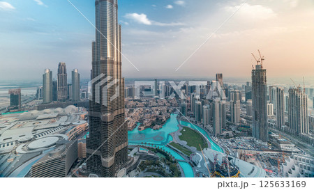 Panoramic skyline view of Dubai downtown with mall, fountains and Burj Khalifa aerial timelapse 125633169