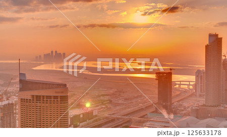 Amazing sunrise aerial view of Dubai downtown skyscrapers morning timelapse, Dubai, United Arab Emirates Amazing sunrise aerial view of Dubai downtown skyscrapers morning timelapse, Dubai, United Arab Emirates 125633178
