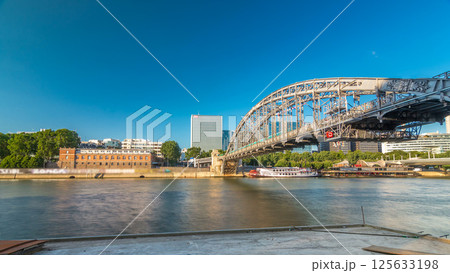 The Austerlitz viaduct in Paris timelapse hyperlapse, seen from bank of the river Seine with a metro train passing 125633198