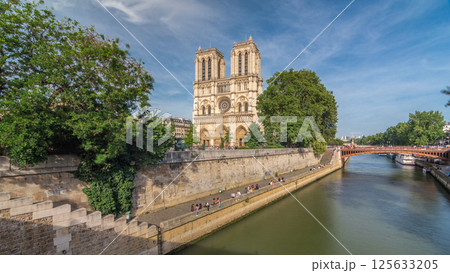 Front facade of cathedral of Notre Dame de Paris, with square full of people in front timelapse hyperlapse 125633205