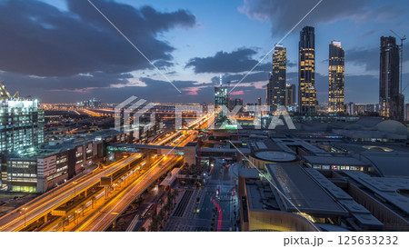 Aerial view of Financial center road night to day timelapse with under construction building Aerial view of Financial center road night to day timelapse with under construction building 125633232