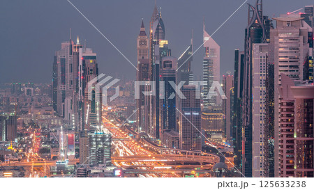 Aerial view to skyscrapers on Dubai downtown and Sheikh Zayed road day to night timelapse, Dubai, United Arab Emirates Aerial view to skyscrapers on Dubai downtown and Sheikh Zayed road day to night timelapse, Dubai, United Arab Emirates 125633238