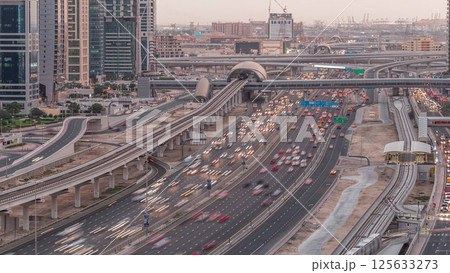 Aerial top view to Sheikh Zayed road near Dubai Marina and JLT day to night timelapse, Dubai. Aerial top view to Sheikh Zayed road near Dubai Marina and JLT day to night timelapse, Dubai. 125633273