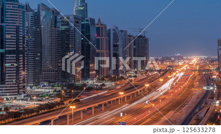 Aerial top view to Sheikh Zayed road near Dubai Marina and JLT night to day timelapse, Dubai. Aerial top view to Sheikh Zayed road near Dubai Marina and JLT night to day timelapse, Dubai. 125633278