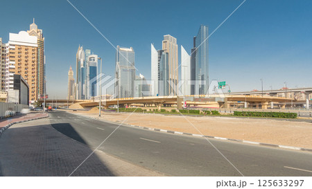 Busy Sheikh Zayed Road timelapse hyperlapse, metro railway and modern skyscrapers around in luxury Dubai city 125633297