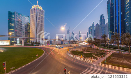 Traffic on intersection and bridge at the Sheikh Zayed Road day to night timelapse Traffic on intersection and bridge at the Sheikh Zayed Road day to night timelapse 125633331