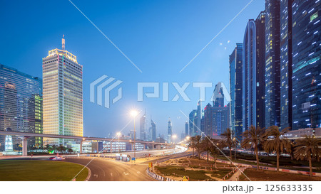 Traffic on intersection and bridge at the Sheikh Zayed Road day to night timelapse 125633335