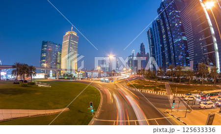 Traffic on intersection and bridge at the Sheikh Zayed Road day to night timelapse 125633336