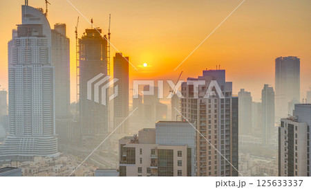 Foggy morning sunrise in downtown of Dubai timelapse. Foggy morning sunrise in downtown of Dubai timelapse. 125633337
