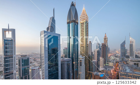 Skyline view of the buildings of Sheikh Zayed Road and DIFC day to night timelapse in Dubai, UAE. 125633342