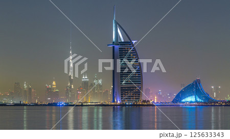 Skyline of Dubai by night with Burj Al Arab from the Palm Jumeirah timelapse hyperlapse. Skyline of Dubai by night with Burj Al Arab from the Palm Jumeirah timelapse hyperlapse. 125633343