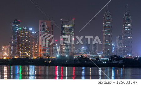 Skyscrapers at the Dubai Internet City illuminated at night timelapse. United Arab Emirates, Middle East Skyscrapers at the Dubai Internet City illuminated at night timelapse. United Arab Emirates, Middle East 125633347
