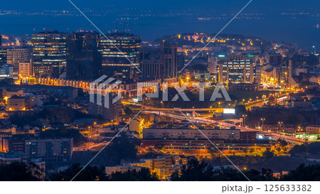 Panoramic view over Lisbon and Almada from a viewpoint in Monsanto night to day timelapse. 125633382