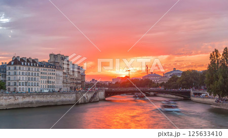 Le Pont D'Arcole bridge at sunset with people and boats timelapse, Paris, France, Europe 125633410