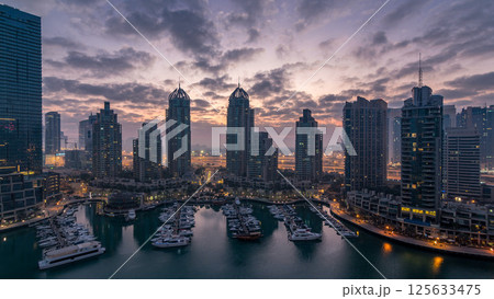 Aerial view of modern skyscrapers night to day timelapse before sunrise in Dubai Marina in Dubai, UAE. 125633475