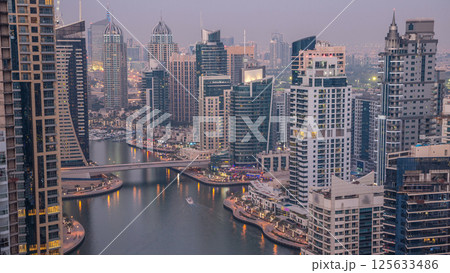 Beautiful aerial top view day to night transition timelapse of Dubai Marina canal 125633486