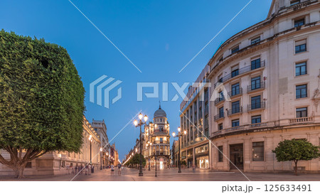 Illuminated Adriatica building on Avenida de la Constitucion at night, Seville, Spain 125633491