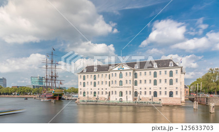 Hyperlapse of the National Maritime Museum with the sailboat replica Amsterdam docked nearby. Amsterdam, Netherlands Hyperlapse of the National Maritime Museum with the sailboat replica Amsterdam docked nearby. Amsterdam, Netherlands 125633703