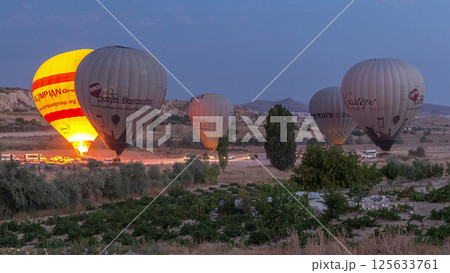 Beautiful colorful hot air balloons take off and flying in clear morning sky timelapse in Cappadocia, Turkey Beautiful colorful hot air balloons take off and flying in clear morning sky timelapse in Cappadocia, Turkey 125633761