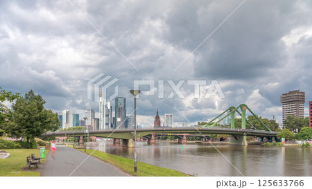 Hyperlapse of Frankfurt's Main Iron Footbridge against the financial district skyscrapers skyline on a sunny day with clouds timelapse. Frankfurt, Germany 125633766