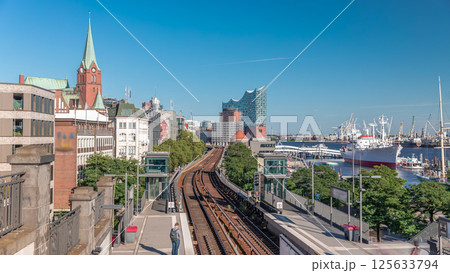 Aerial hyperlapse of trains arriving at Landungsbrucken station in Hamburg, Germany Aerial hyperlapse of trains arriving at Landungsbrucken station in Hamburg, Germany 125633794
