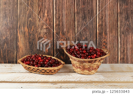 Harvesting in august, cherries on wooden background, rustic style, healthy natural food concept, store advertisement, business card for cafe, invitation with place for text, selective focus Harvesting in august, cherries on wooden background, rustic style, healthy natural food concept, store advertisement, business card for cafe, invitation with place for text, selective focus 125633843
