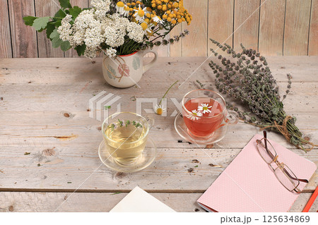 Floral composition of wild herbs and flowers on a wooden table in a rustic style, autumn background, tansy,  125634869