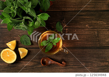 Medicinal herbal tea or infusion of peppermint with lemon with flowers, concept of alternative traditional medicine, collection of useful herbs for treatment according . Medicinal herbal tea or infusion of peppermint with lemon with flowers, concept of alternative traditional medicine, collection of useful herbs for treatment according . 125634948