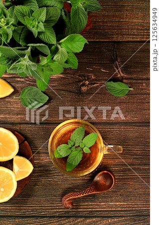 Medicinal herbal tea or infusion of peppermint with lemon with flowers, concept of alternative traditional medicine, collection of useful herbs for treatment according . Medicinal herbal tea or infusion of peppermint with lemon with flowers, concept of alternative traditional medicine, collection of useful herbs for treatment according . 125634949